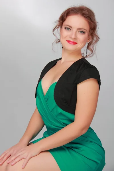 Portrait of a beautiful woman in a green dress — Stock Photo, Image