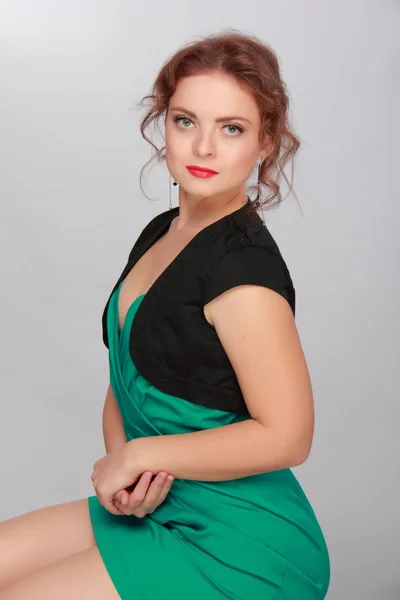 Portret van een mooie vrouw in een groene jurk — Stockfoto