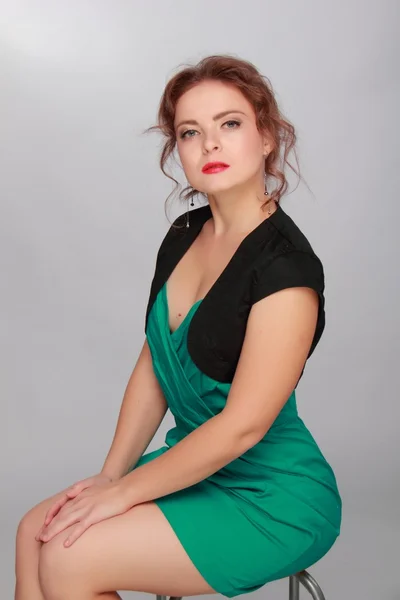 Portrait of a beautiful woman in a green dress — Stock Photo, Image