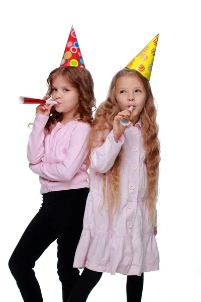 Pretty party girls blowing noisemakers — Stock Photo, Image