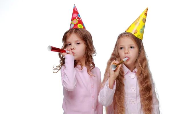 Party girls blowing noisemakers — Stock Photo, Image