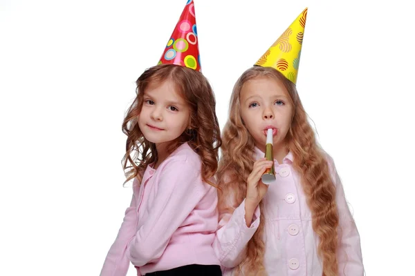 Party girls blowing noisemakers — Stock Photo, Image