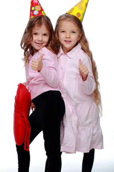 Party girls blowing noisemakers — Stock Photo, Image