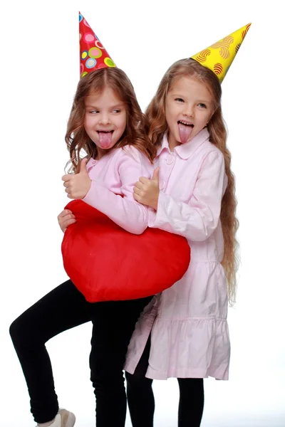 Party girls blowing noisemakers — Stock Photo, Image