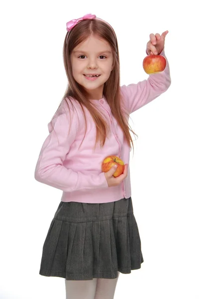 Malá dívka hospodářství dvě jablka — Stock fotografie