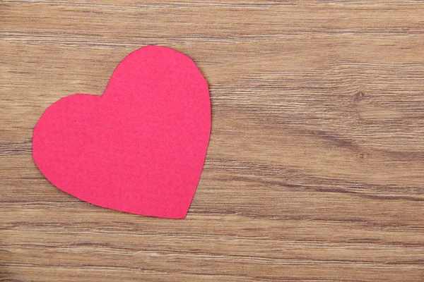 Heart symbol on a wooden background — Stock Photo, Image