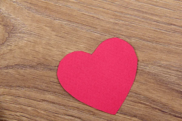 Heart symbol on a wooden background — Stock Photo, Image