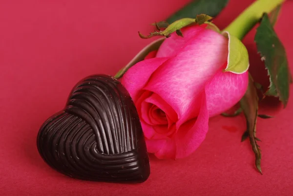 Lindas rosas rosa e corações de chocolate — Fotografia de Stock