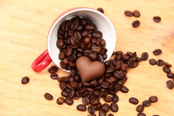 Tazza con chicchi di caffè e caramelle al cioccolato — Foto Stock