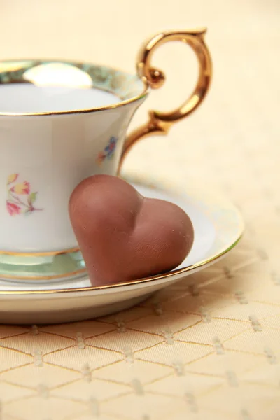 Light cup and saucer with candy — Stock Photo, Image