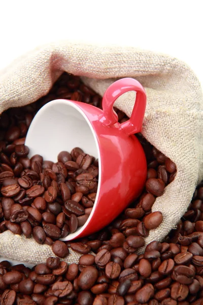 Coffee beans in red cup with heart symbol over burlap sack — Stock Photo, Image