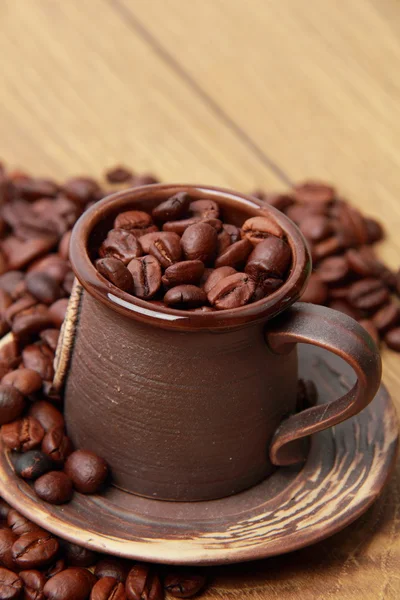 Delicious coffee beans in ceramic cup — Stock Photo, Image