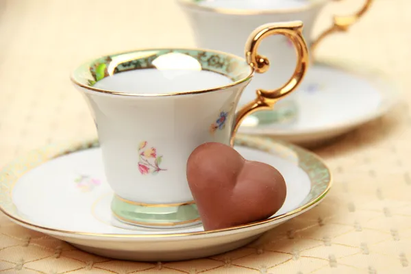 Classic coffee cup chocolate candy on the tablecloth — Stock Photo, Image