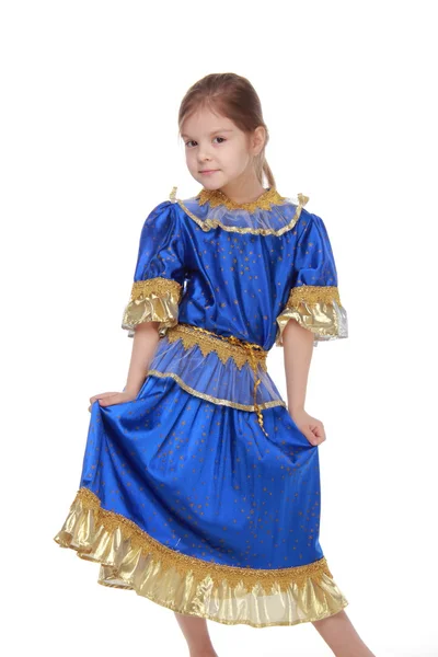 Entzückendes kleines Mädchen in blauem Kleid auf weißem Hintergrund — Stockfoto