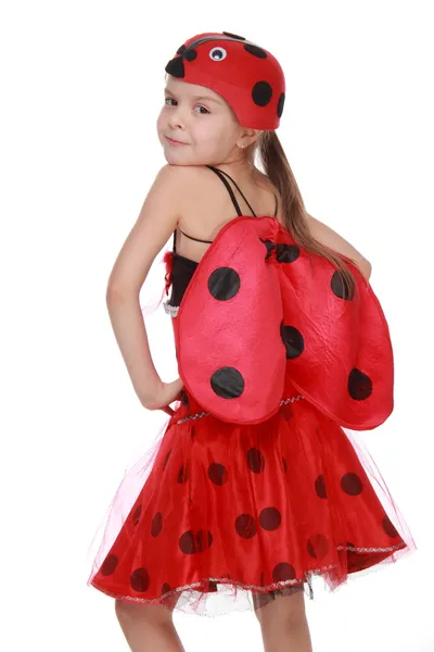 Fröhliches kleines Mädchen im roten Kostüm mit Flügeln Marienkäfer — Stockfoto