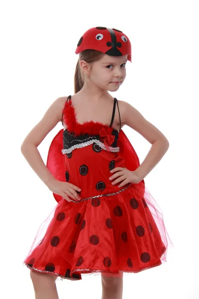 Veselá holčička, oblečený v červené kostým s křídly Beruška — Stock fotografie