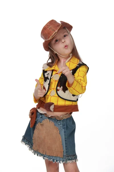 Hermosa niña en un disfraz de vaquero sobre fondo blanco — Foto de Stock