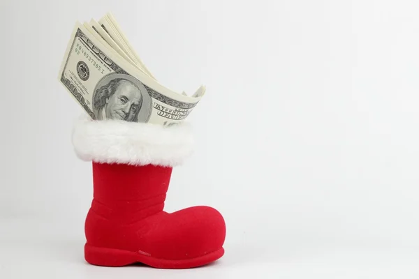 Lots of 100 dollars banknotes in a Christmas boot — Stock Photo, Image