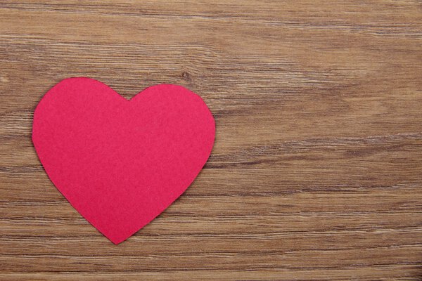 Red heart isolated on wooden background