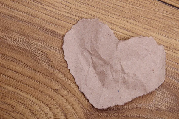Símbolo do coração feito de papel sobre fundo de madeira — Fotografia de Stock