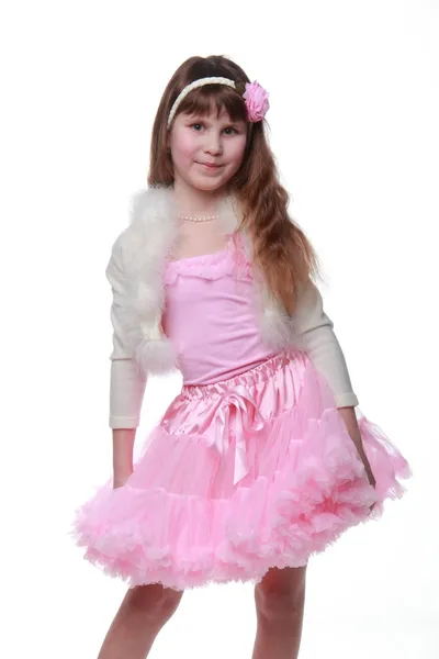 Kind mit schönem Haar in rosa Tutu posiert für die Kamera auf weißem Hintergrund — Stockfoto