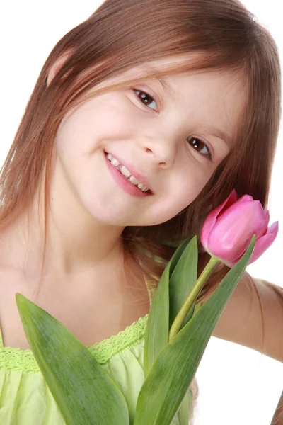 Portrait of a beautiful little girl with a tulip — Stock Photo, Image