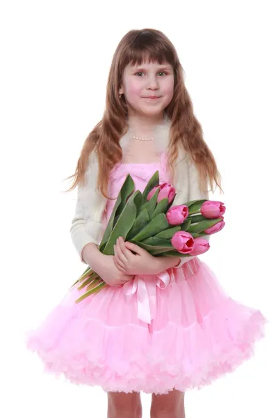 Bambina con un grande bouquet su sfondo bianco in vacanza — Foto Stock