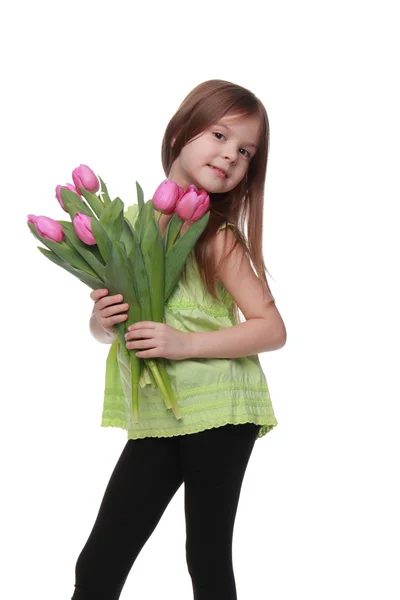 Imagen de una hermosa niña con un ramo de tulipanes —  Fotos de Stock