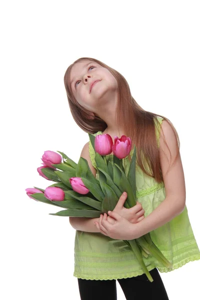 Beautiful little girl with a bouquet of tulips — Stock Photo, Image