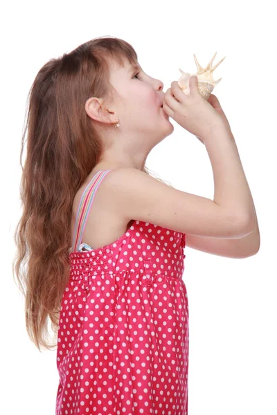 Smiley child plays with natural big seashell — Stock Photo, Image