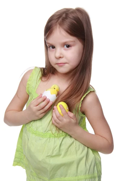 Happy little girl with spring fluffy chicken and yellow Easter egg — Stock Photo, Image