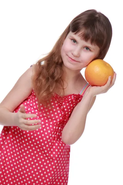 Niña en vestido brillante sosteniendo una toronja —  Fotos de Stock