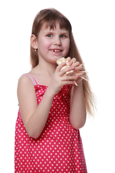 Cheerful little girl holding a seashell — Stock Photo, Image