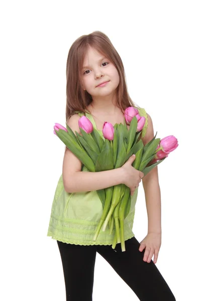 Hermosa niña con un gran ramo de tulipanes — Foto de Stock