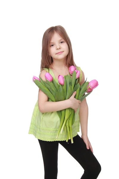 Menina bonito com um grande buquê de tulipas — Fotografia de Stock