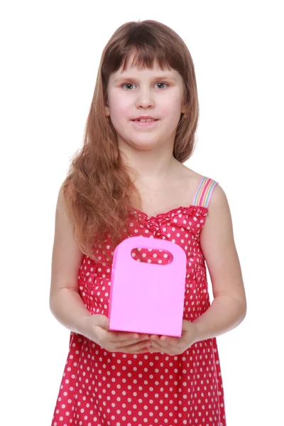 Healthy little girl in a summer dress holding a gift — Stock Photo, Image