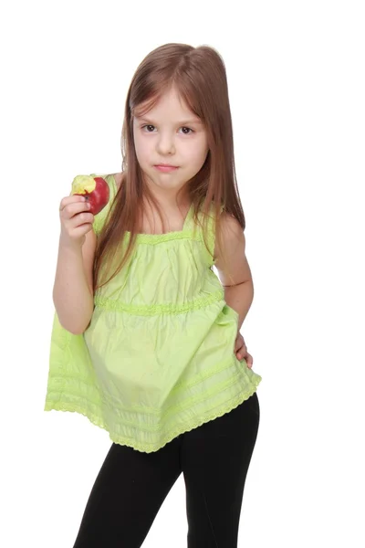 Cute little girl with a sweet smile holding an apple — Stock Photo, Image