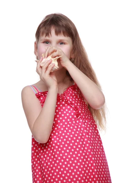 Cheerful little girl holding a seashell — Stock Photo, Image