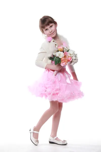 Little girl in a dress with a bouquet of flowers — Stock Photo, Image