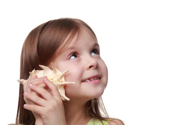 Cute little girl with a seashell — Stock Photo, Image