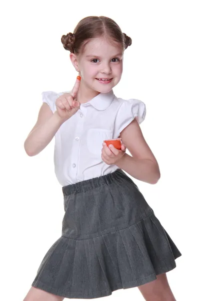 Studio beeld van een schoolmeisje poseren met oranje verf — Stockfoto