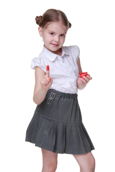 Portait of a schoolgirl posing with red paint — Stock Photo, Image