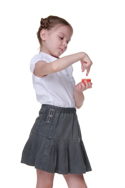 Lovely schoolgirl posing with orange paint — Stock Photo, Image