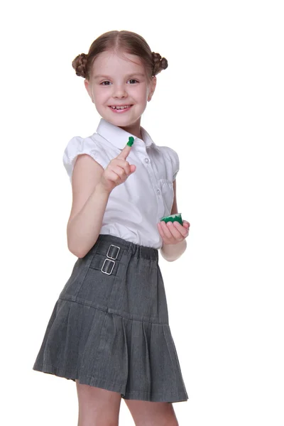 Lovely schoolgirl posing with green paint — ストック写真