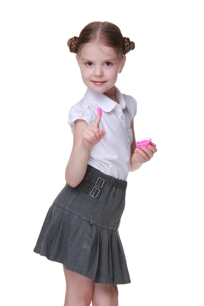 Lovely schoolgirl posing with pink paint — Stock Photo, Image