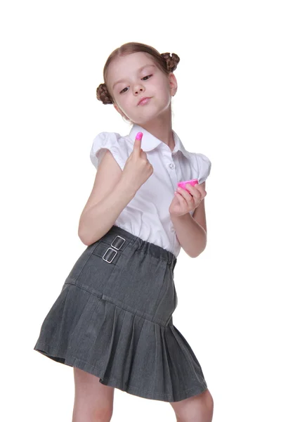 Mooie schoolmeisje poseren met roze verf — Stockfoto