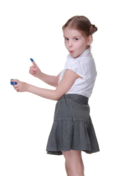 Happy schoolgirl wearing uniform and posing with blue paint — Stock Photo, Image
