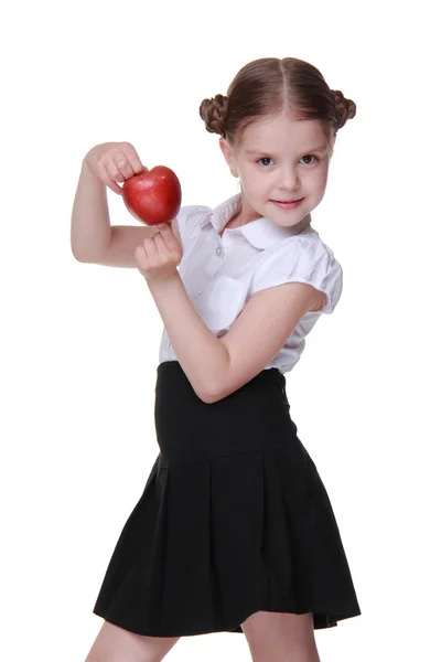 Porträtt av en vacker skolflicka som innehar ett äpple — Stockfoto