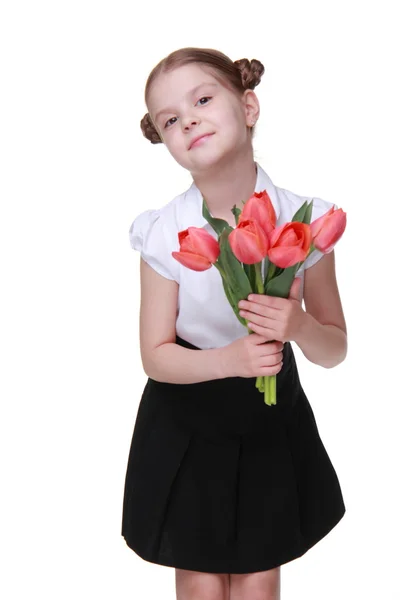 Estudante bonito com um buquê de tulipas — Fotografia de Stock