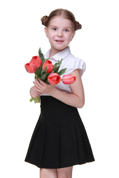 Cute schoolgirl with a bouquet of tulips — Stock Photo, Image